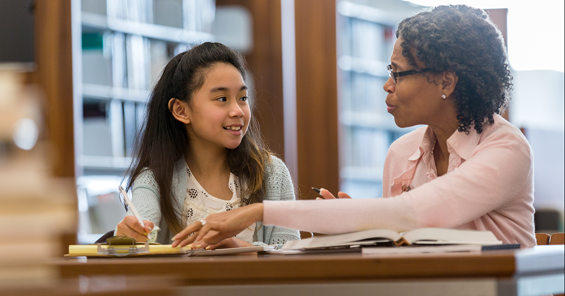 a teacher helping a student in the classroom