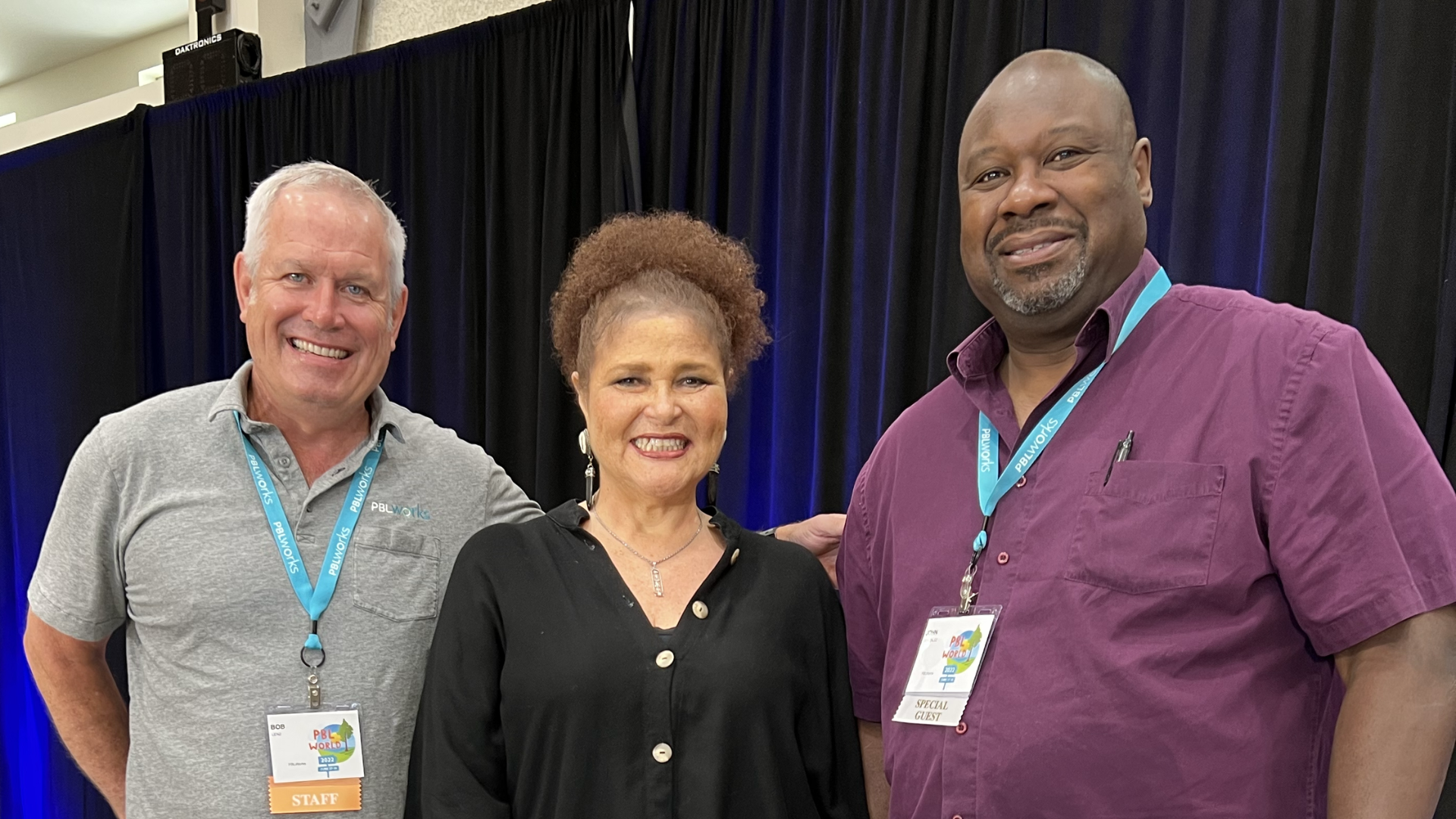 Dr. Lisa Delpit poses for a picture with PBLWorks CEO Bob Lenz and Board Chair John G