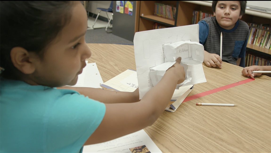 PBL student showing work to fellow students in the classroom