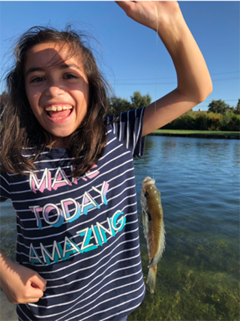 Girl showing that she caught a fish