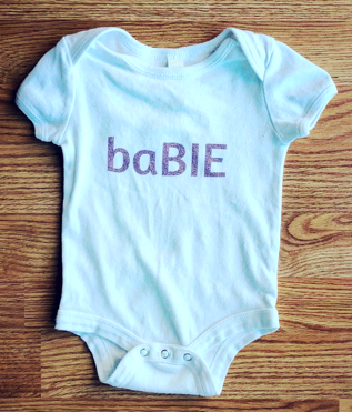 a baby onesy with baby on the front spelled b a b i e