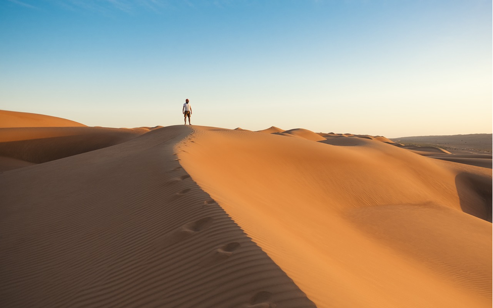 one person standing in the desert