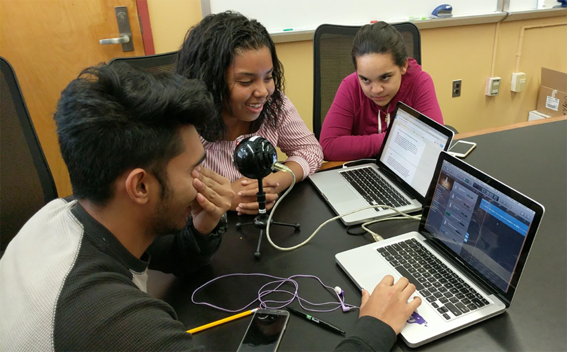 A team listens to the playback of their recording.