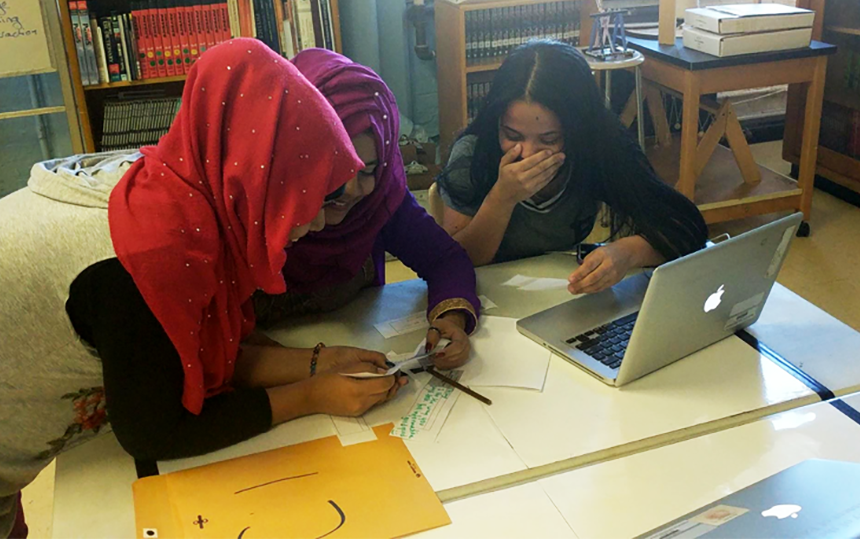 A team of students reading their “fan mail” written by people who listened to their podcast.