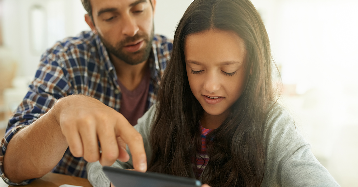 a dad helping his daughter with a PBL project at home