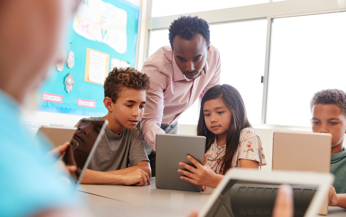 Teacher helping students in a PBL classroom