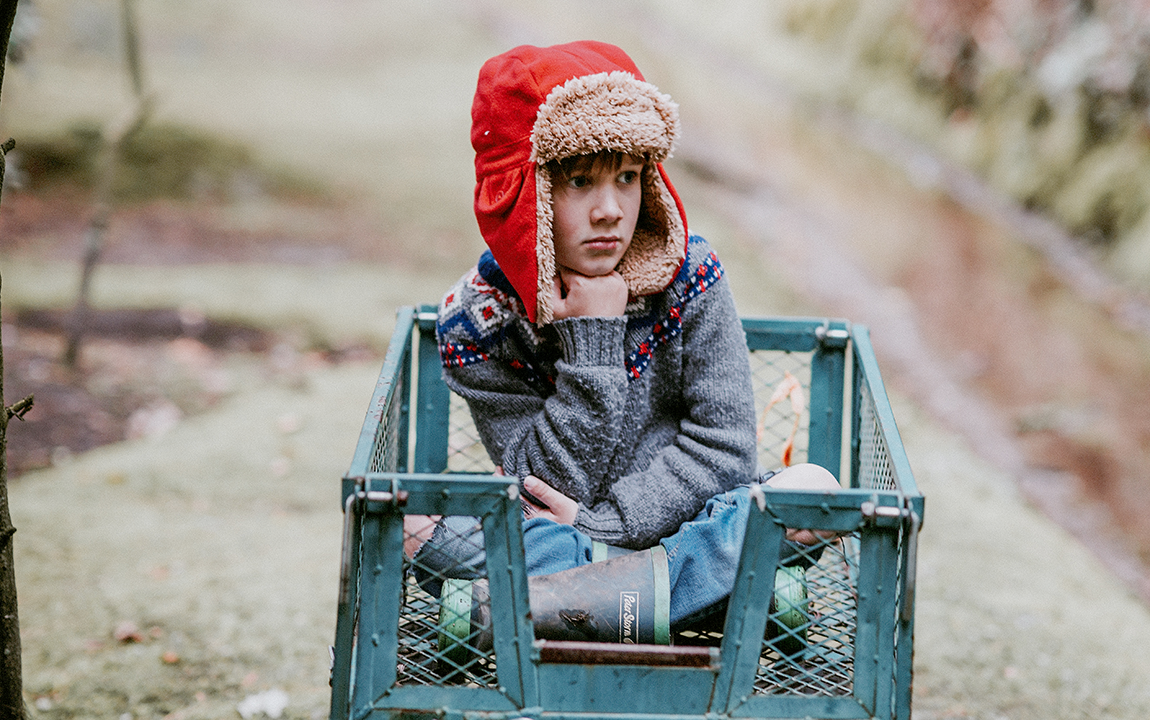 a young boy thinking/reflecting