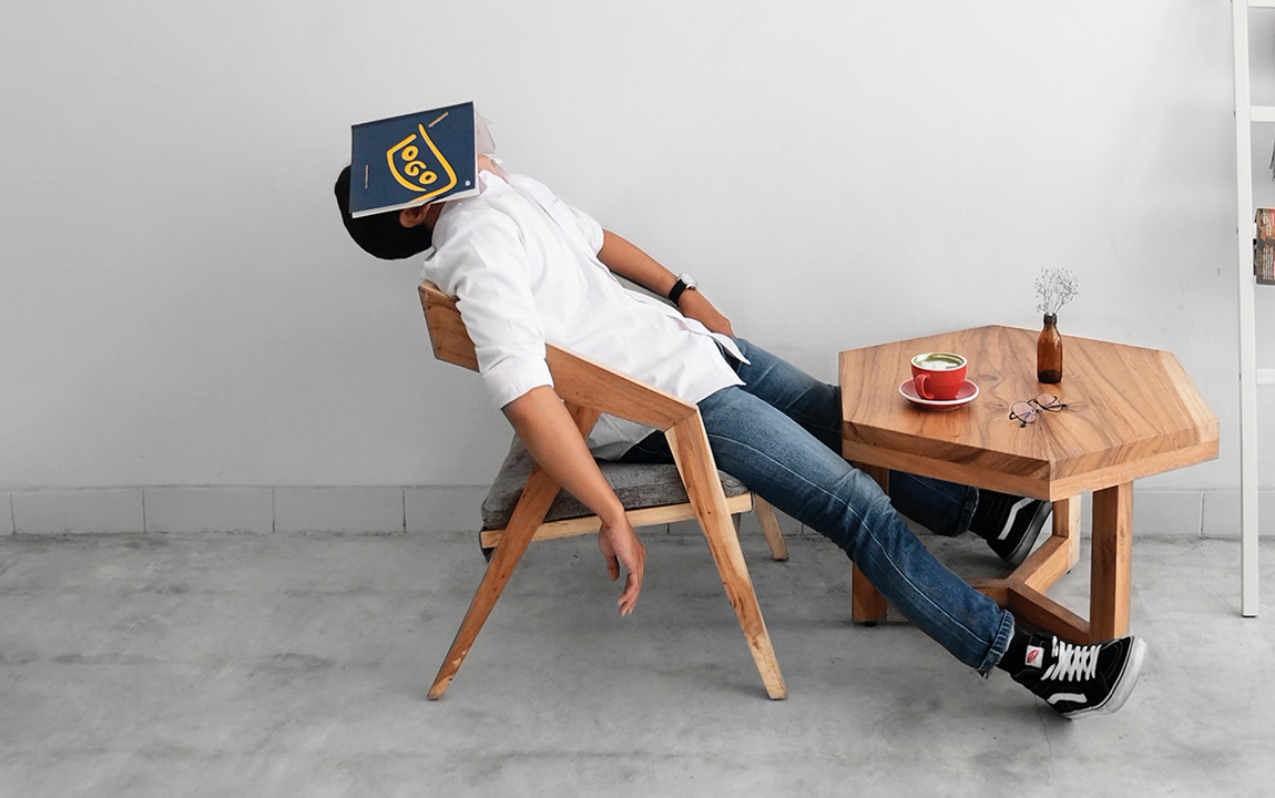 man asleep with book on his head - project overload