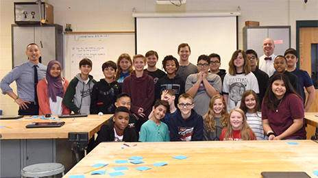 group picture of students and teacher in the classroom