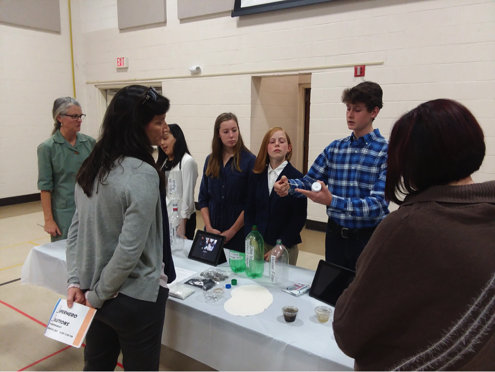 Students presenting their project at an exhibition