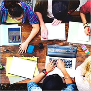 student gathered around a table studying