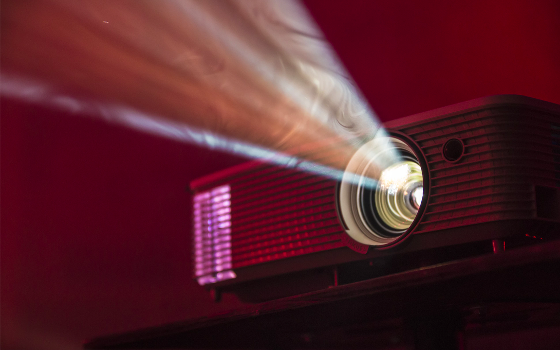 a closeup of overhead projector in dark room