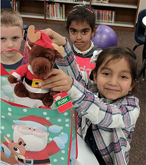 kids creating Christmas gift bags for their PBL project