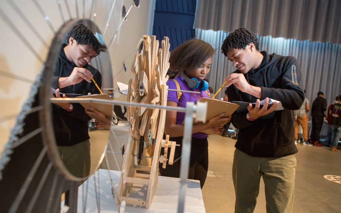 Teacher assisting student with a project