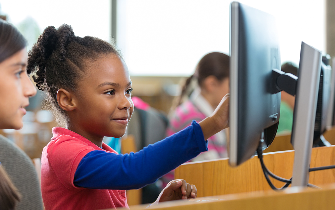 student in class at a computer