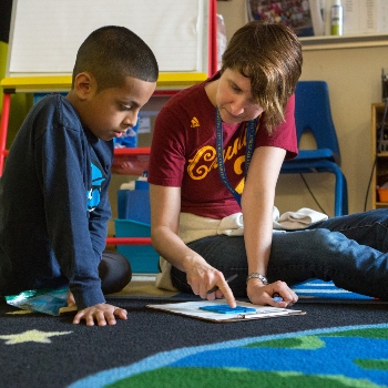 Teacher assisting a student with an assignment