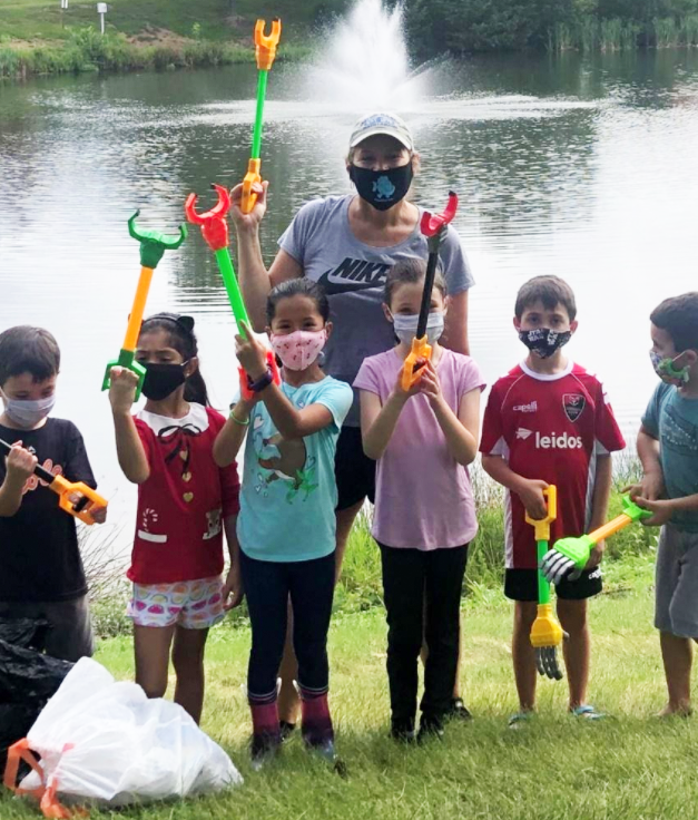 group of students and teacher at pond