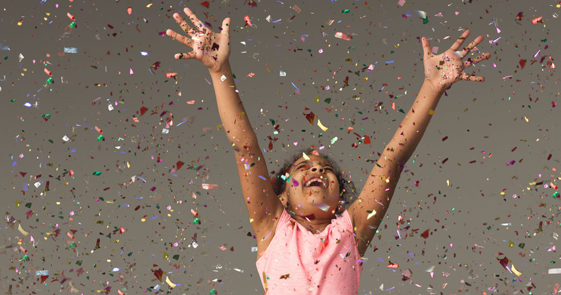 girl celebrating with confetti in the air