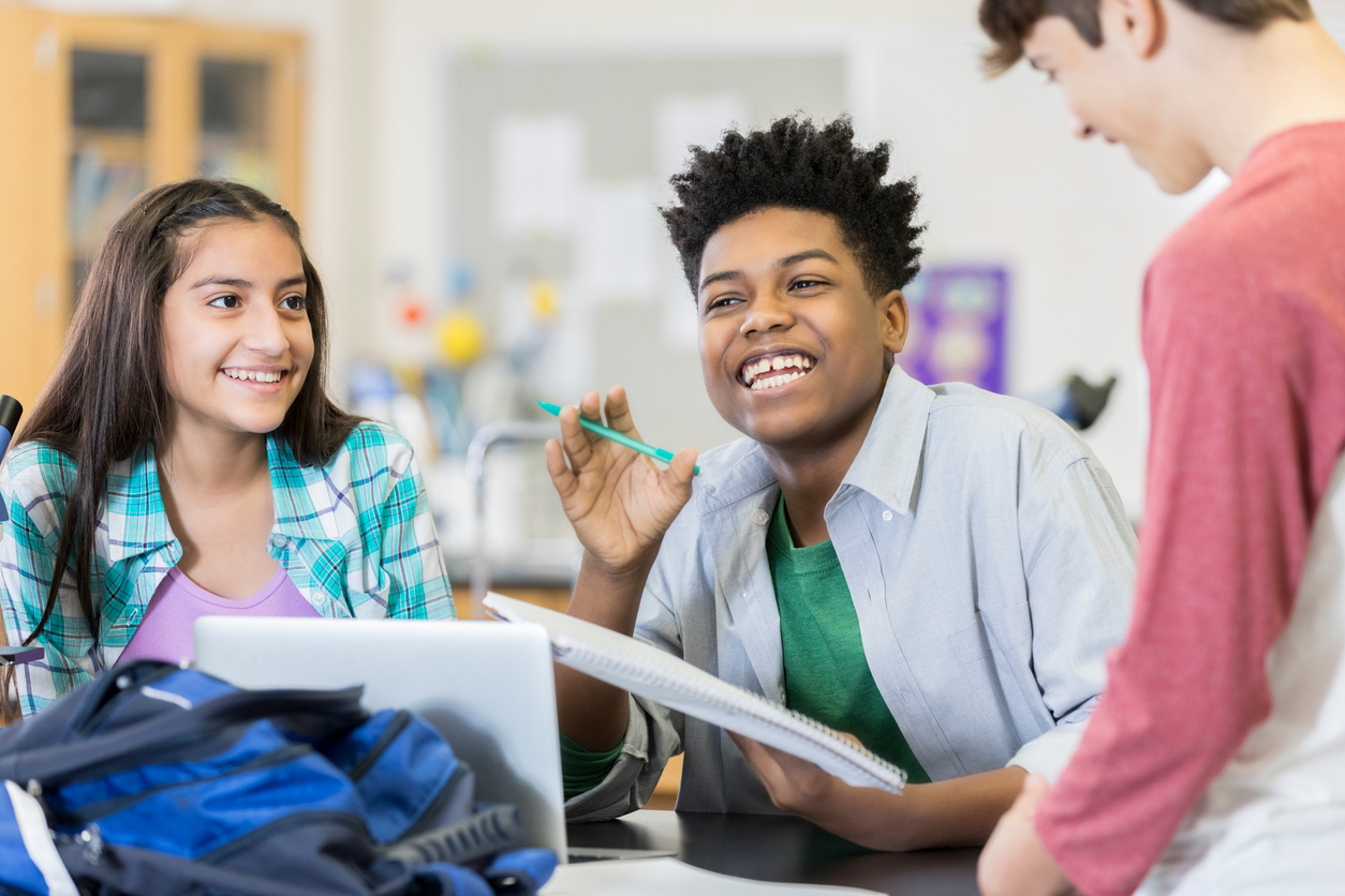 Diverse group of male and female high school friends brainstorm project ideas.