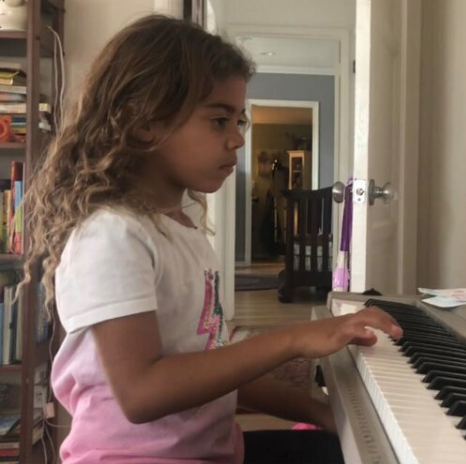 young student playing piano