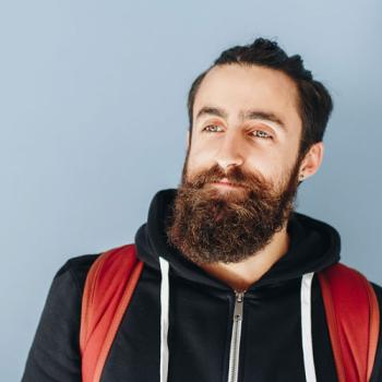 teacher with beard wearing backpack