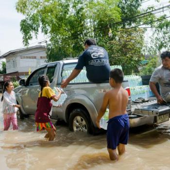 People around car on in a flood disaster