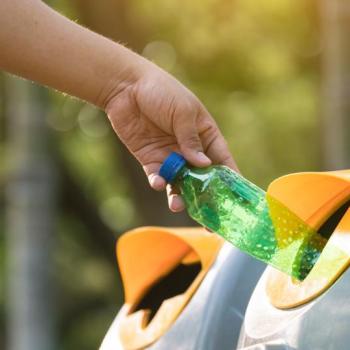 Student recycling a bottle