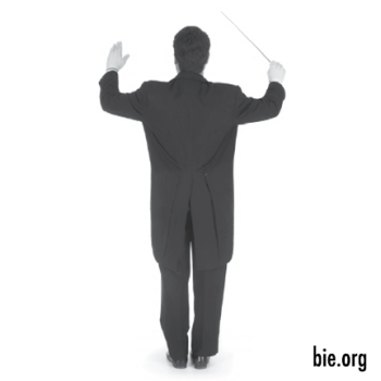 a conductor standing with his back to the viewer