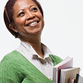 teacher holding notebooks