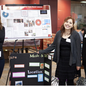 teachers in front of a project board