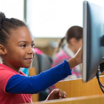 student in class at a computer