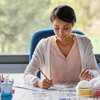 teaching sitting at desk with papers