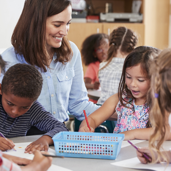 teacher with students working on project