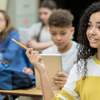 girl answering a question in the classroom