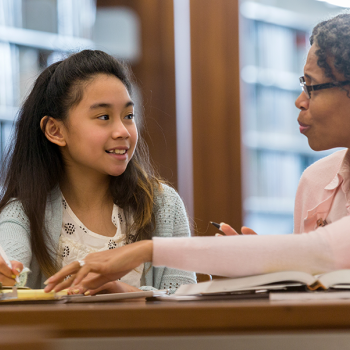 a teacher helping a student in a PBL classroom