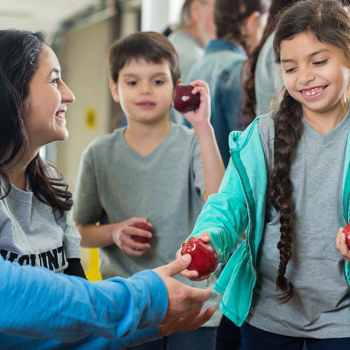 students giving out food at a food bank