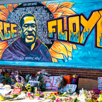 mural of George Floyd with flowers and signs