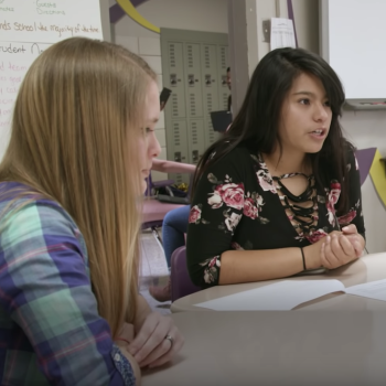 Two female students in a discussion in class