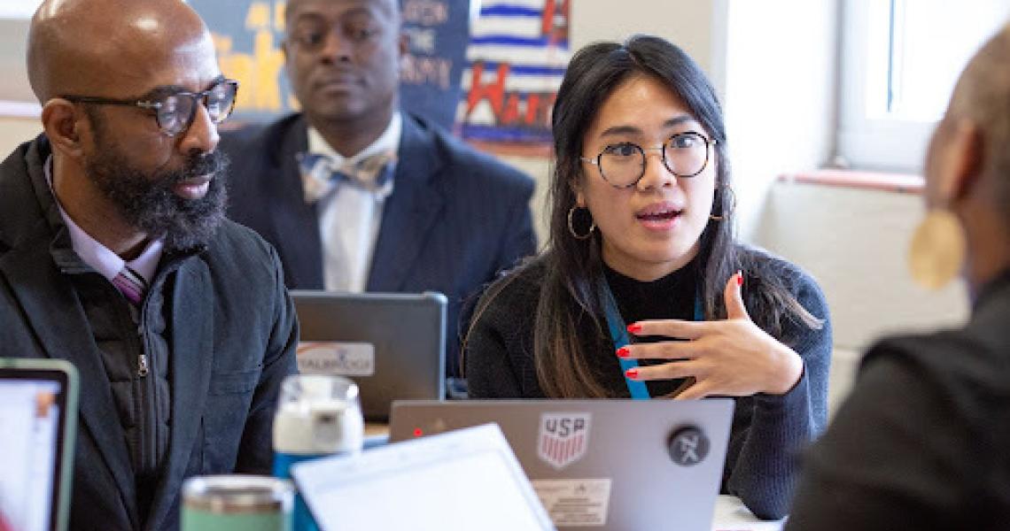 Individuals at Desk in discussion