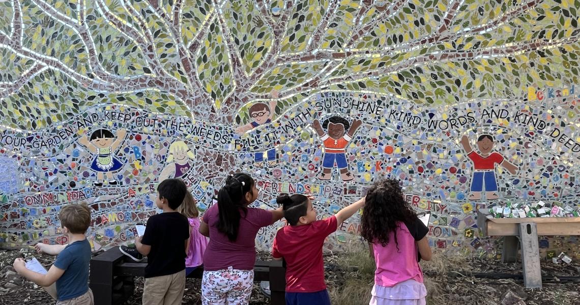 Students gathered around an artwork 