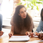 photo of 3-4 teachers talking/meeting