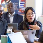 Individuals at Desk in discussion